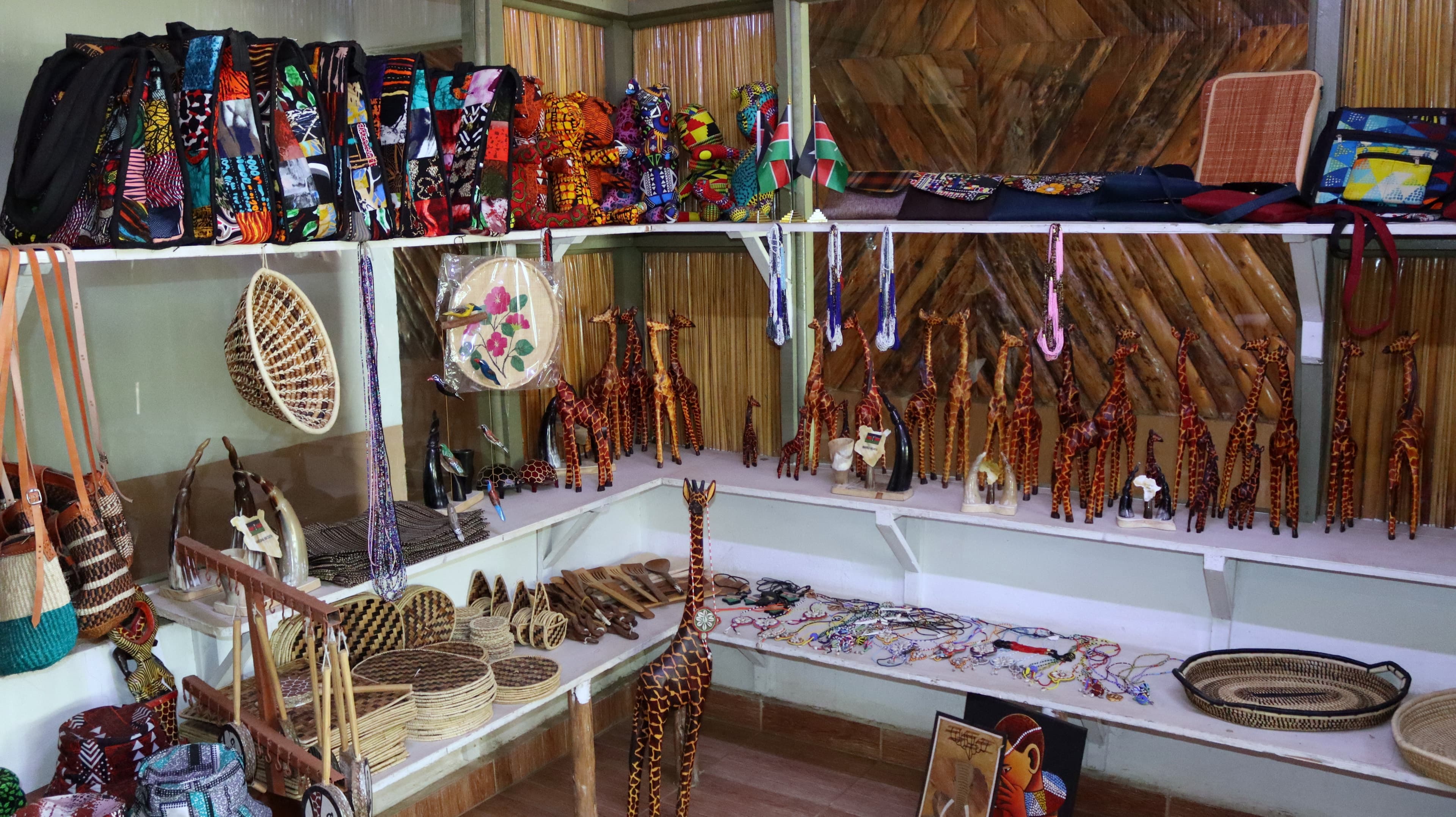 Crafts, bags and carved giraffes on display in a shop at Lake Naivasha Crescent Camp