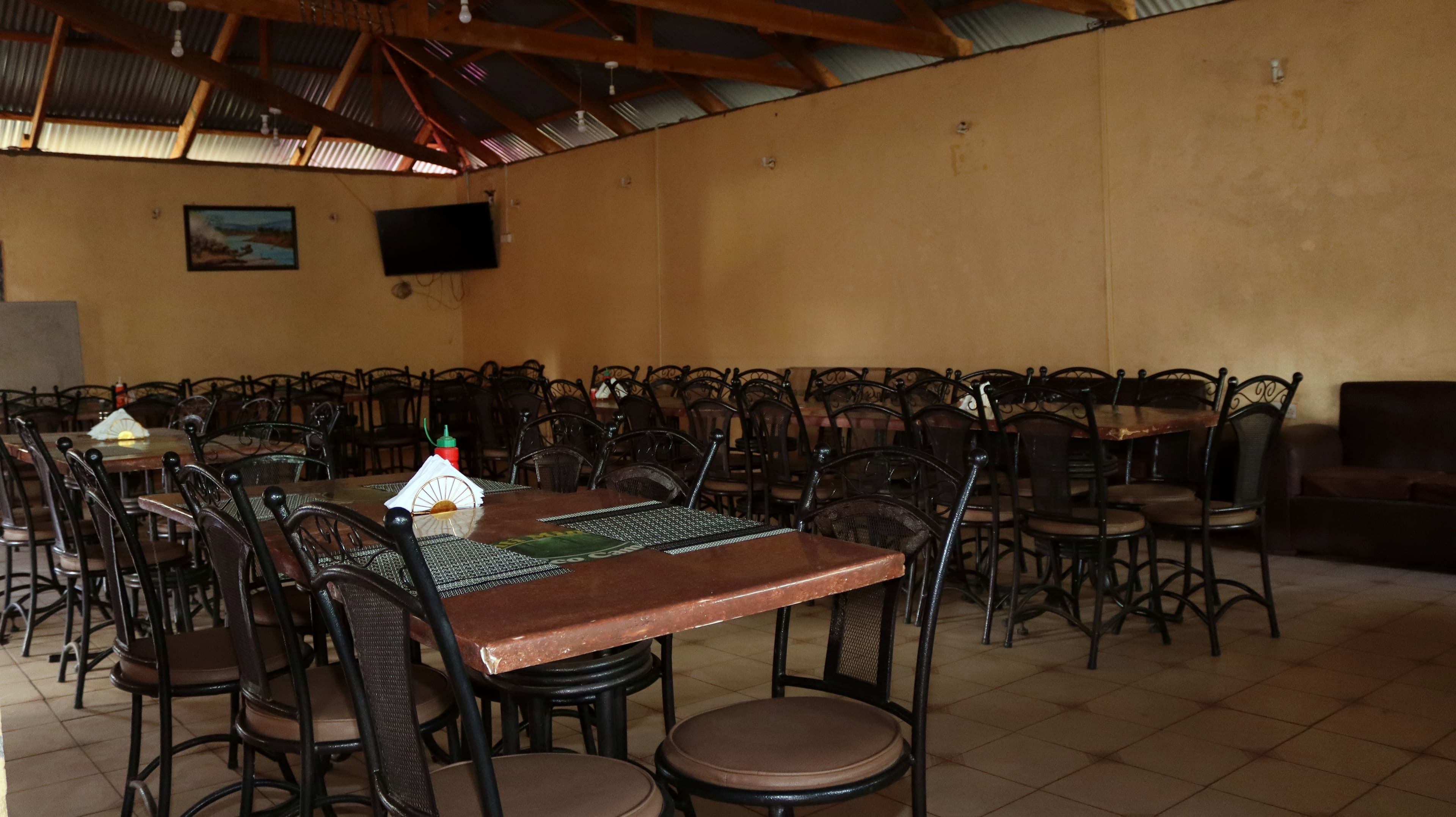 The dining area at Miti Mingi Eco Camp, set with tables and chairs