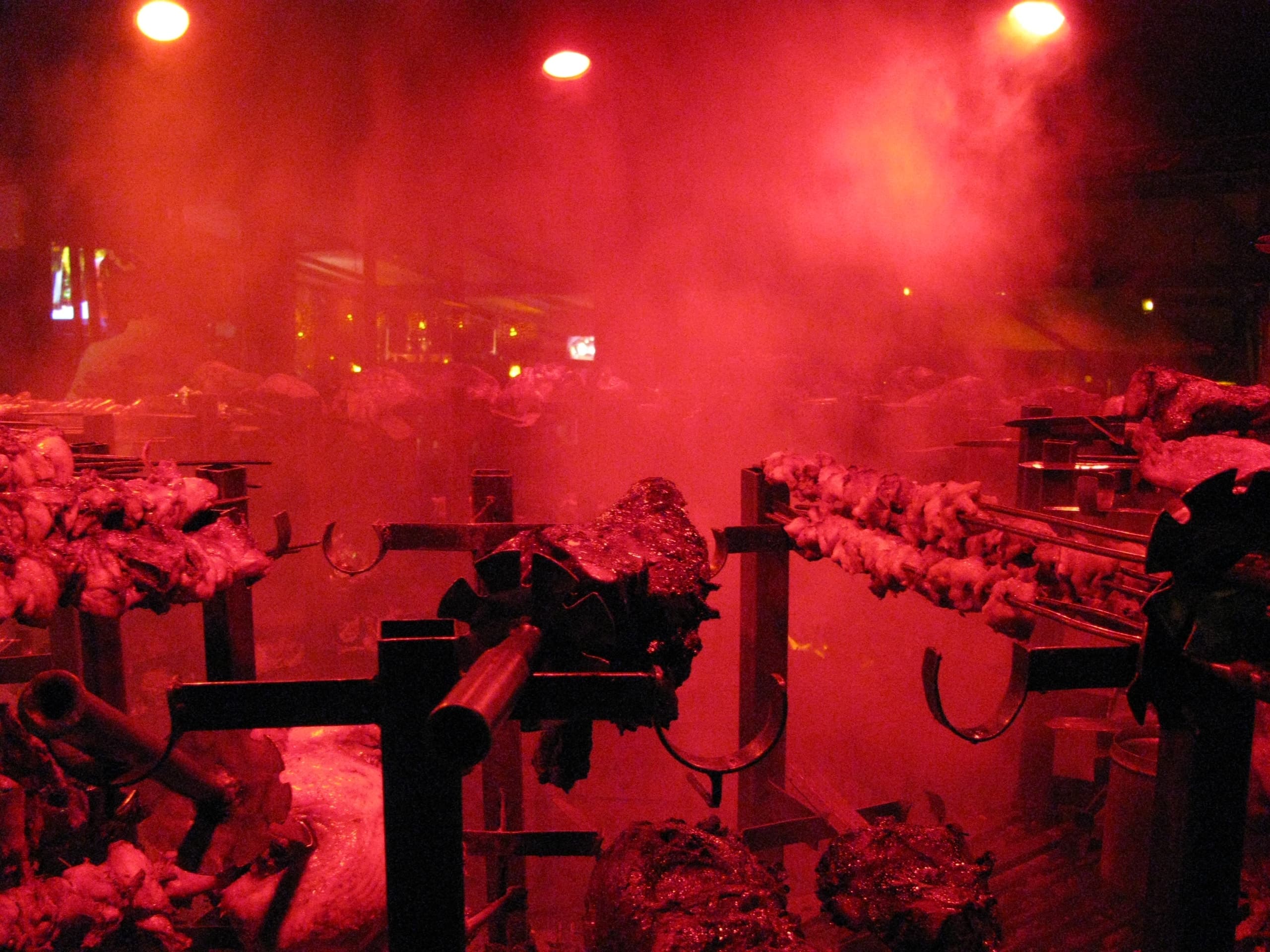 Meats grilling over the charcoal pit at the Carnivore restaurant in Nairobi