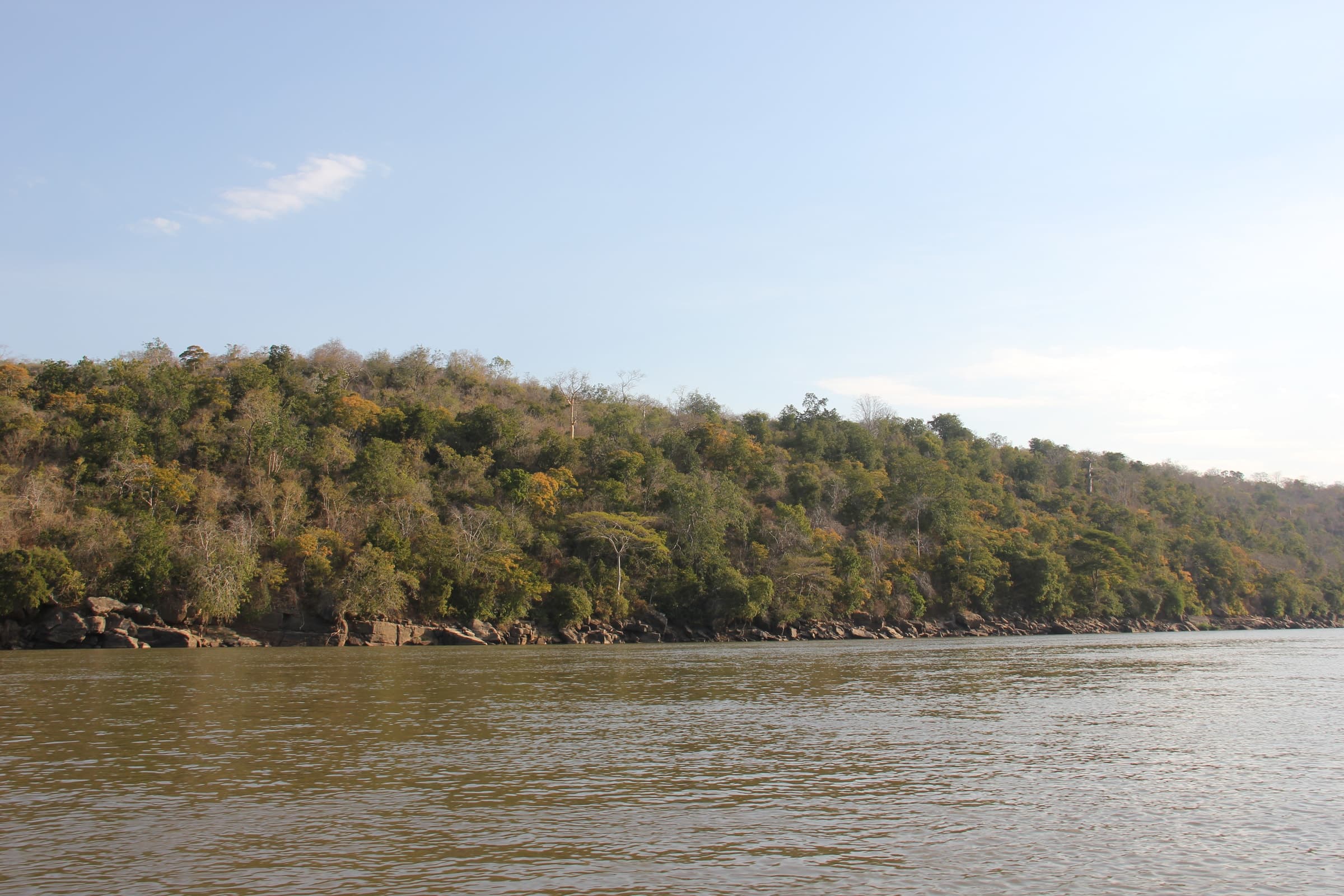 A broad river below a wooded hill in the Selous Game Reserve, Tanzania